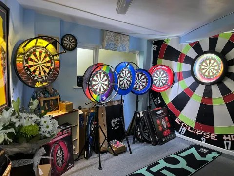 Several dartboards in a game room.