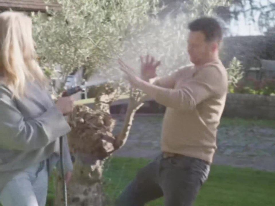 Stacey sprays Joe with a hose pipe in the cute sizzle reel