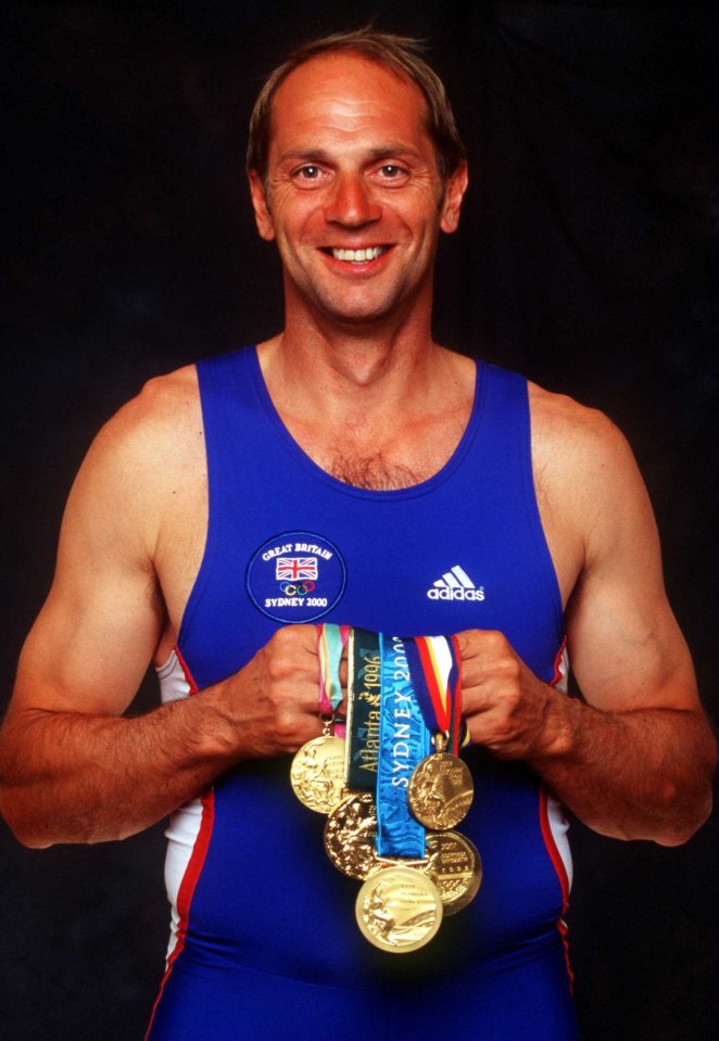 Steve Redgrave of Great Britain holding his five Olympic gold medals.