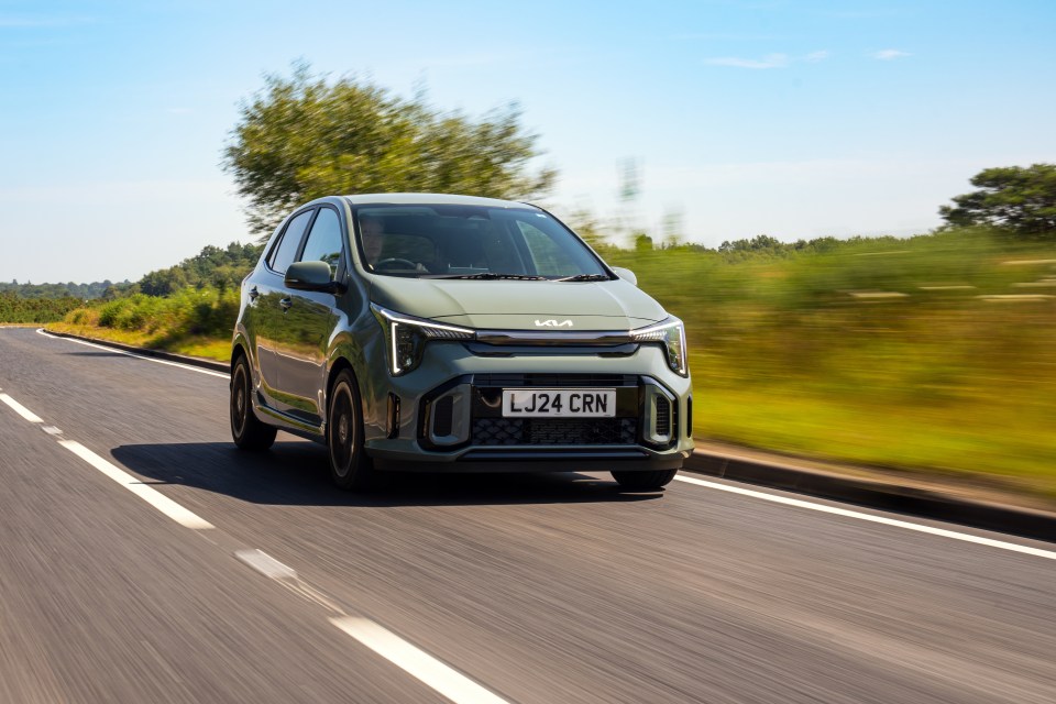 Kia Picanto driving on a road.