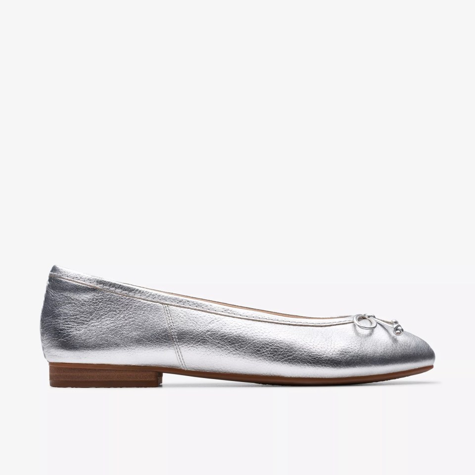 Silver ballet flat with a small bow.