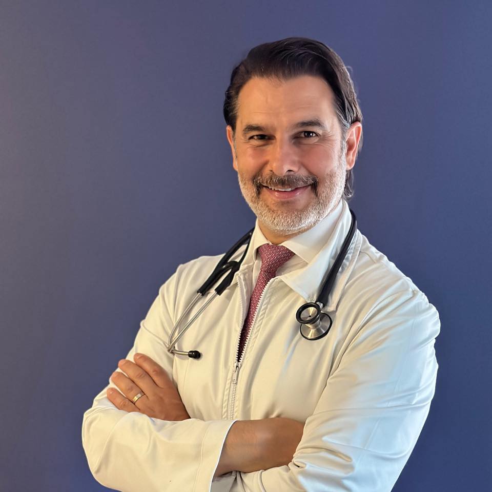 Smiling doctor with arms crossed.