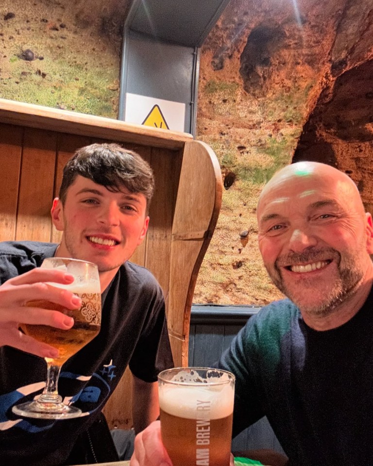 A man and his son enjoying beers together.