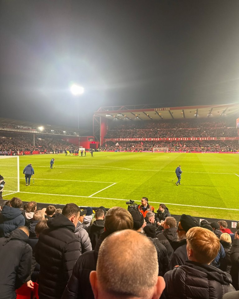 View of a soccer game from the stands at night.