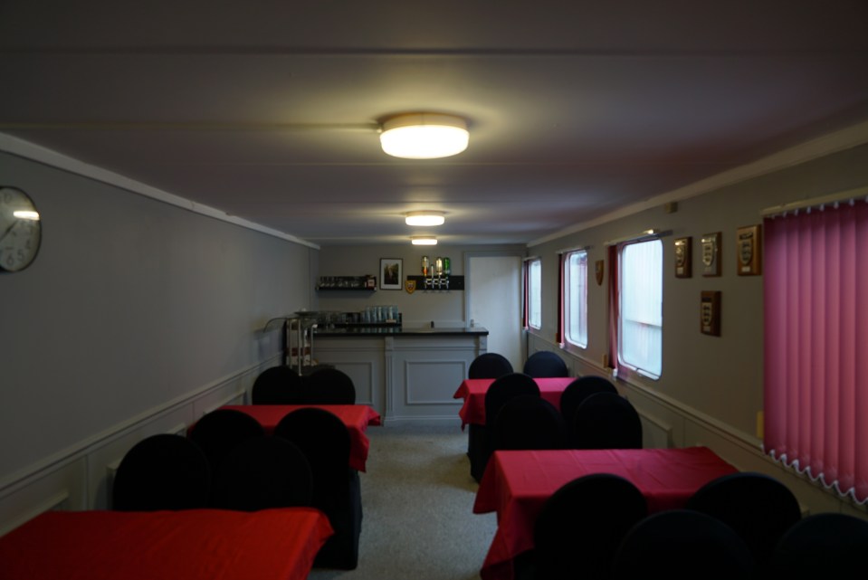 Interior of Tamworth FC function room with tables and chairs.