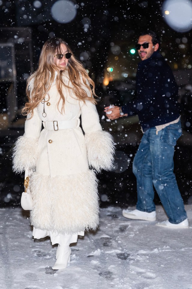 Sydney Sweeney and Jonathan Davino walking in the snow.