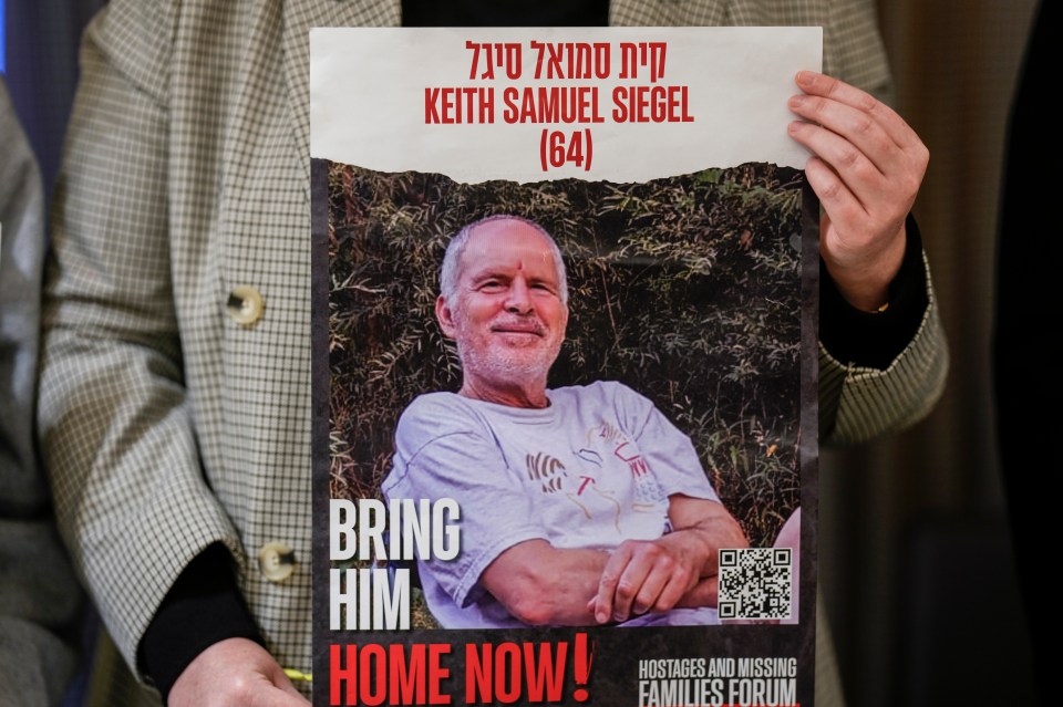 A woman holds a poster demanding the return of Keith Samuel Siegel (64), an Israeli-American hostage.