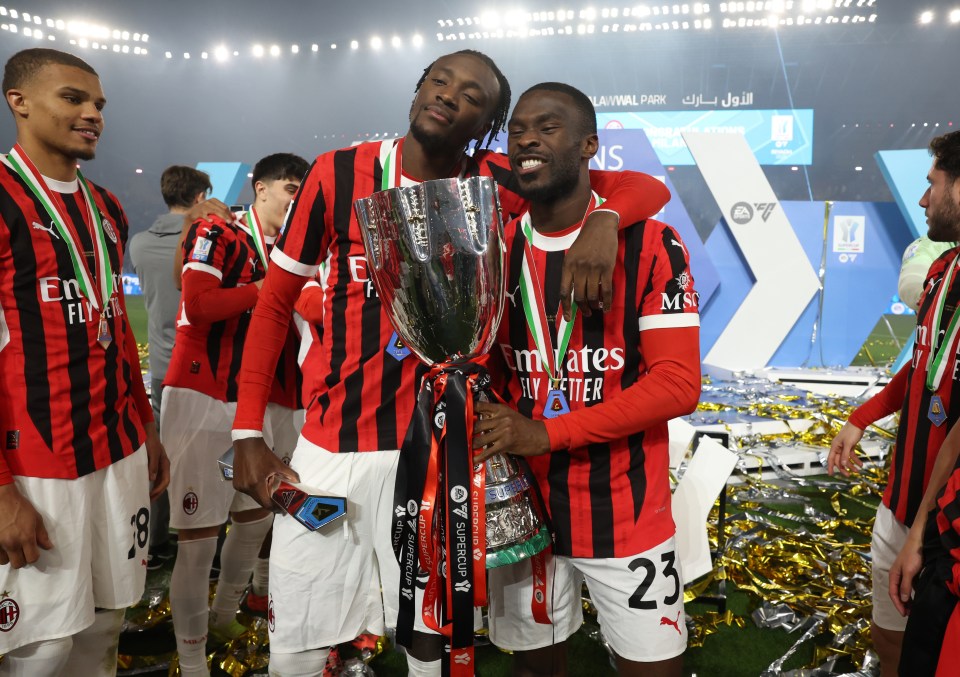 AC Milan players Tammy Abraham and Fikayo Tomori celebrate winning the Italian Super Cup.