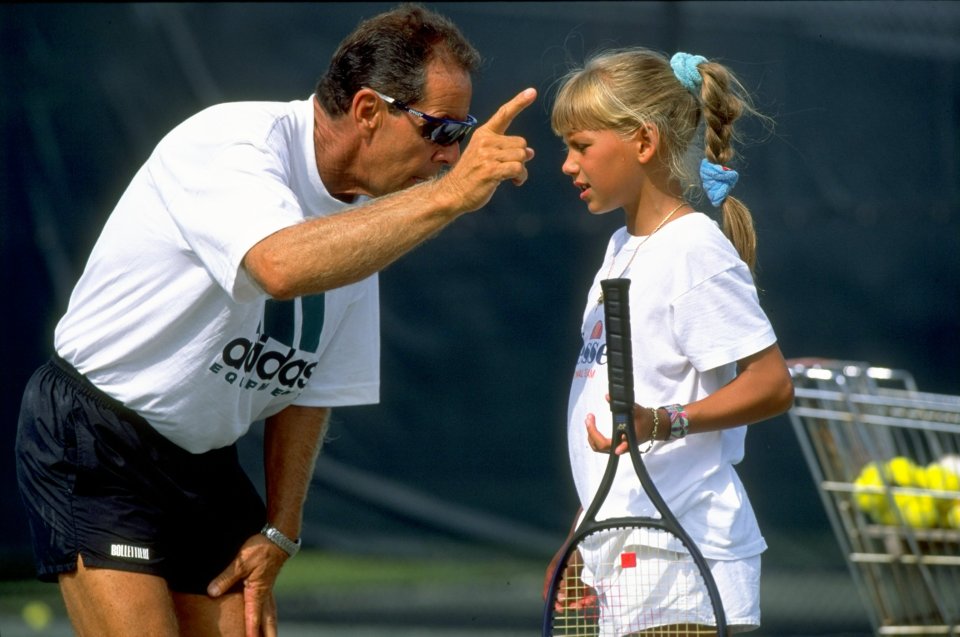 Tennis coach Nick Bollettieri instructing a young Anna Kournikova.