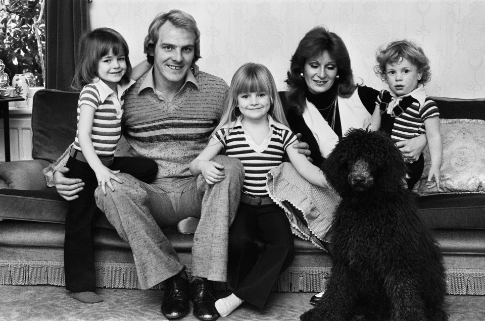 Black and white photo of Terry Yorath, a Coventry City football player, at home with his family and dog.