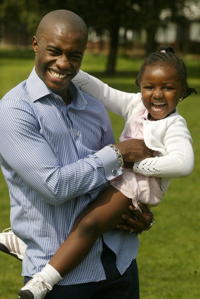 Tim Campbell holding his young daughter.