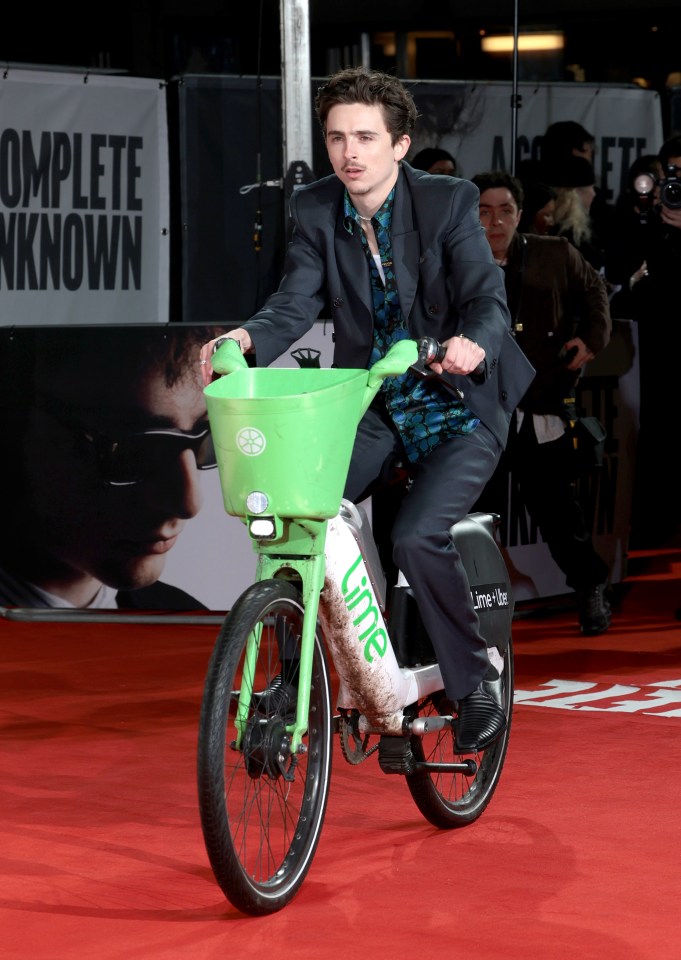 Timothée Chalamet riding a Lime bike on a red carpet.