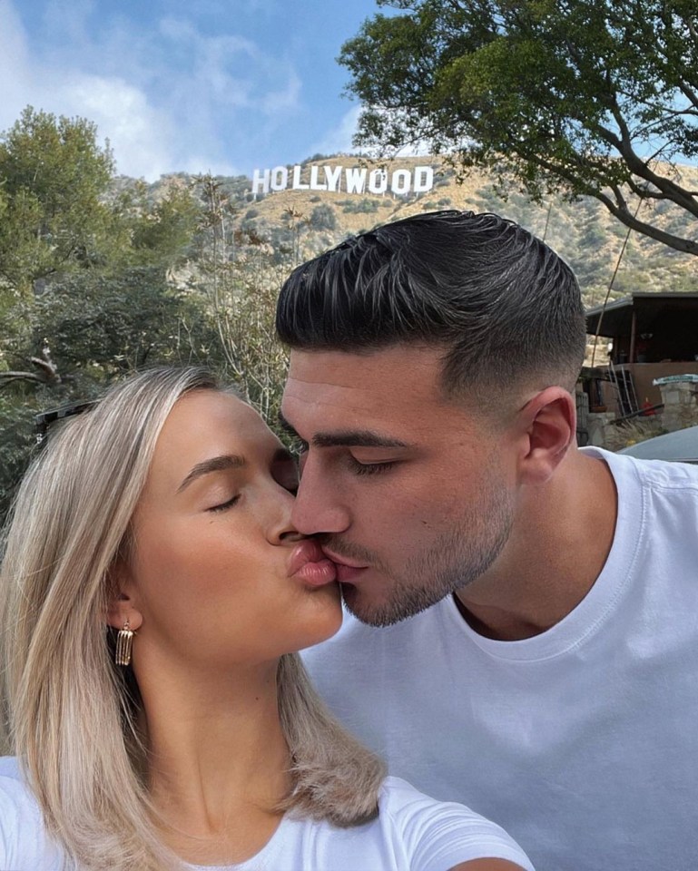 Tommy Fury and Mollie-Mae Hague kissing in front of the Hollywood sign.