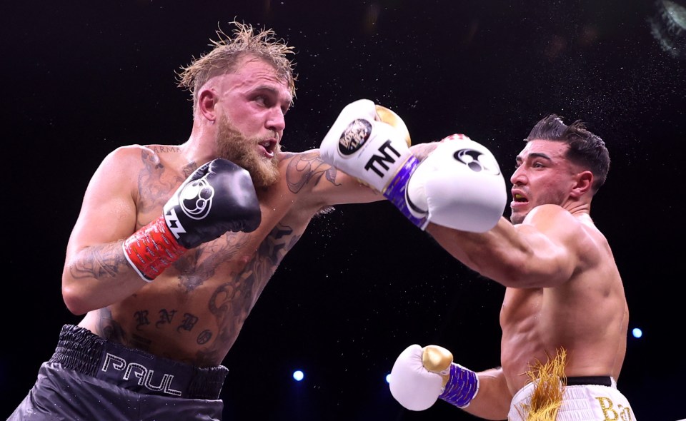 Tommy Fury punches Jake Paul during a boxing match.