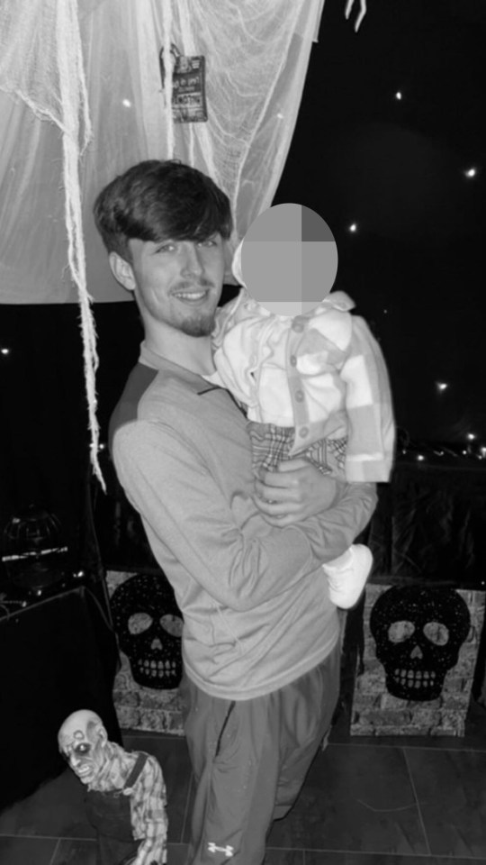 Black and white photo of a man holding a baby.