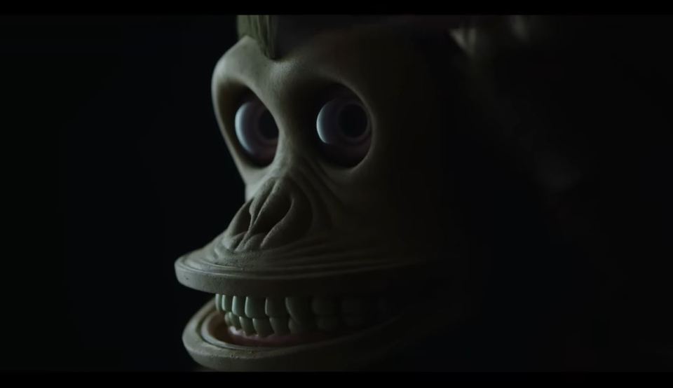 Close-up of a grotesque monkey face from a movie trailer.