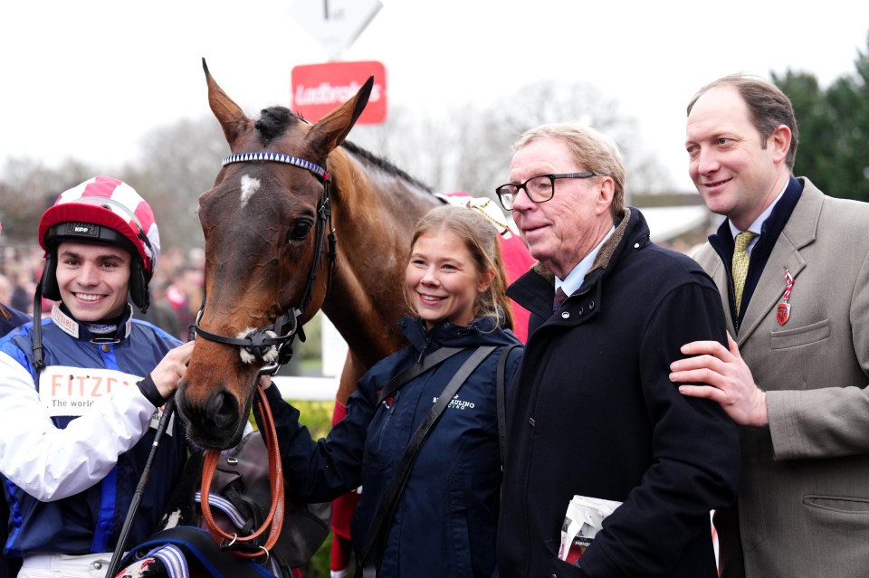 Winning team celebrating with their horse after a race.