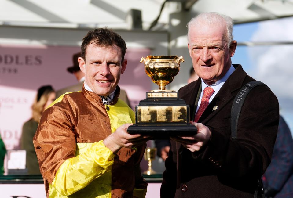 Jockey Paul Townend and trainer Willie Mullins holding the Gold Cup trophy.