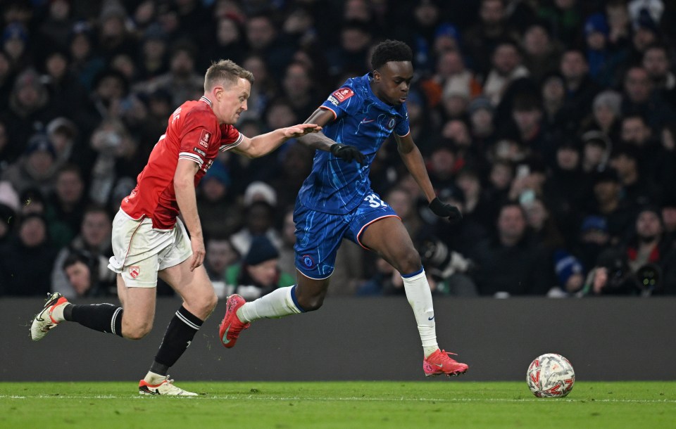 Chelsea's Tyrique George dribbling past Morecambe's Luke Hendrie.