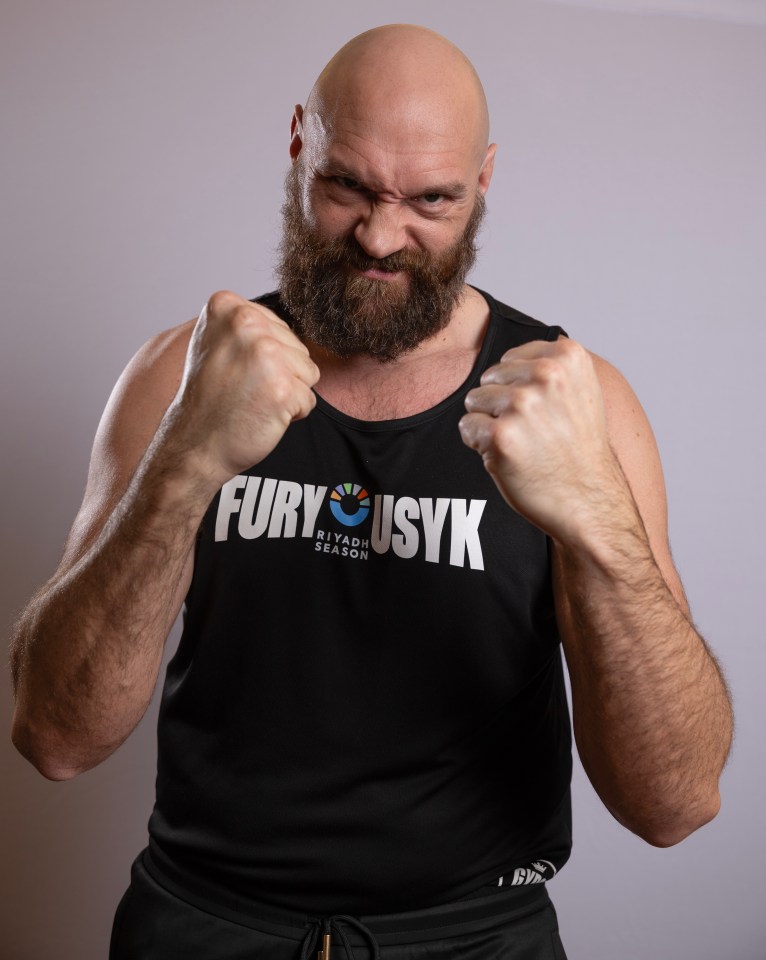 Portrait of Tyson Fury in a black tank top with "Fury Usyk Riyadh Season" printed on it.