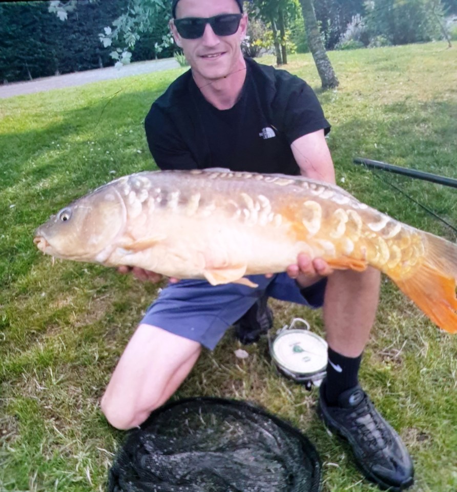 Man holding a large carp.