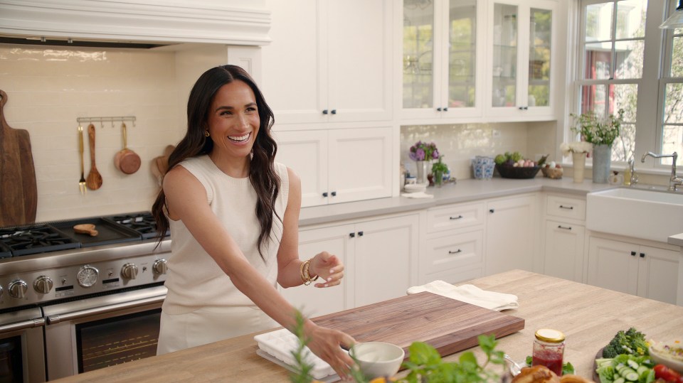 Meghan Markle in her new Netflix series, smiling in a kitchen.