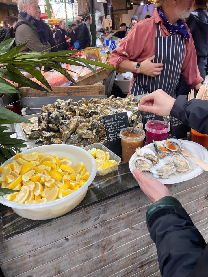 Oysters on ice with lemon wedges and various sauces.