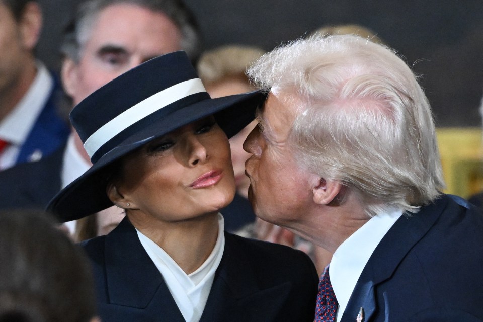 Donald Trump kissing Melania Trump at an inauguration ceremony.