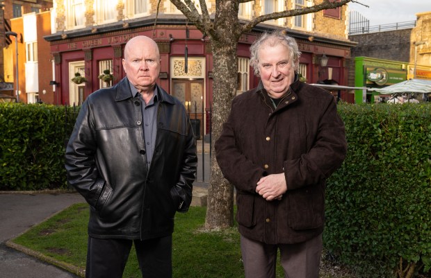 Paul Bradley and Steve McFadden, actors from EastEnders, standing outside The Queen Victoria pub.