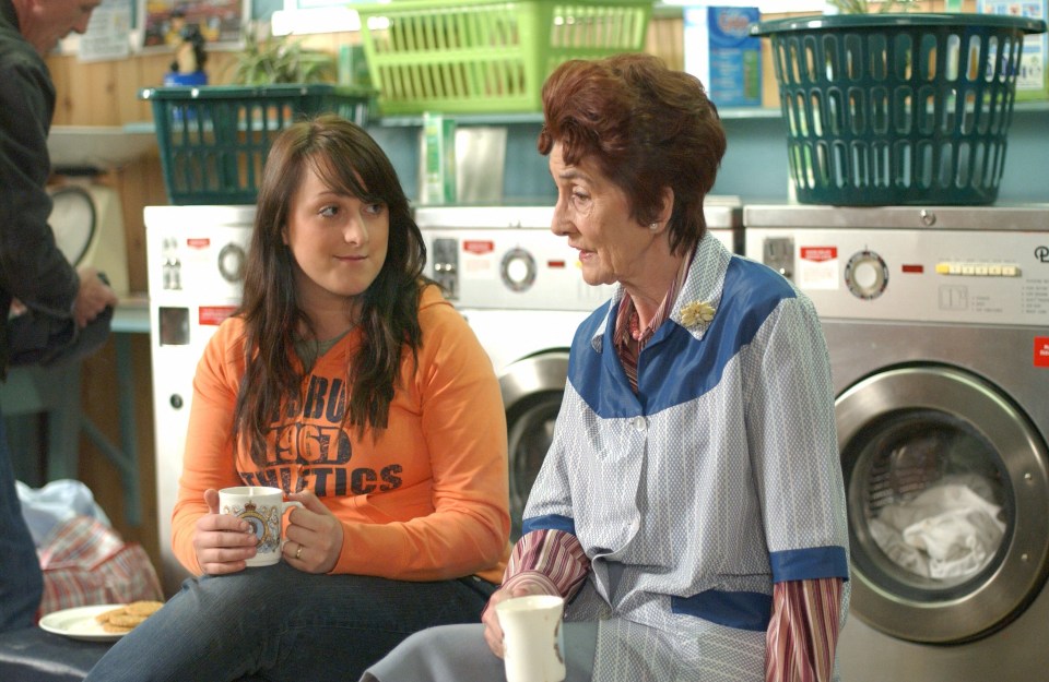 Scene from EastEnders showing Sonia Fowler and Dot Branning having a conversation in a laundromat.