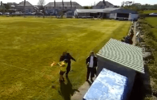 A football coach punches a linesman during a game.