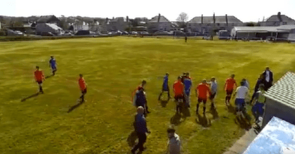 A football coach punches a linesman during a game.