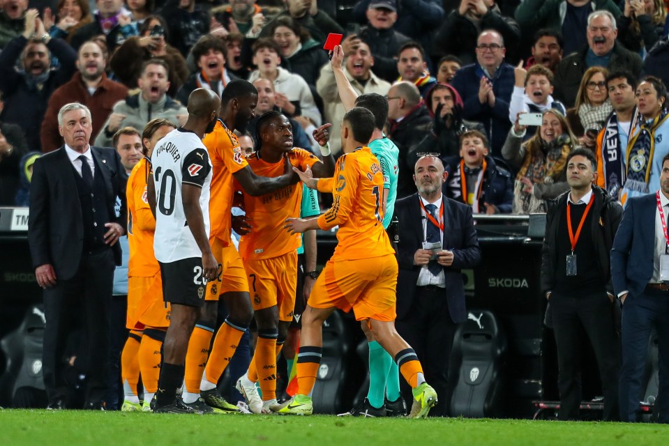 Vinicius Junior of Real Madrid receives a red card.