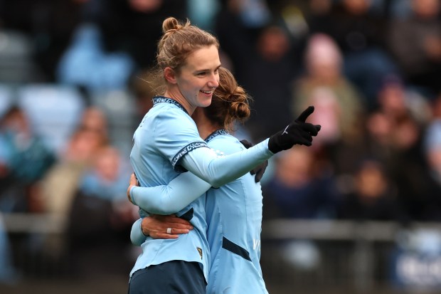 Vivianne Miedema of Manchester City celebrates a goal with a teammate.