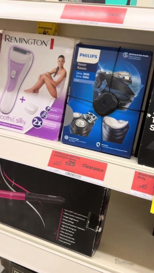 Reduced-price electric razors and hair removal devices at a Sainsbury's store.