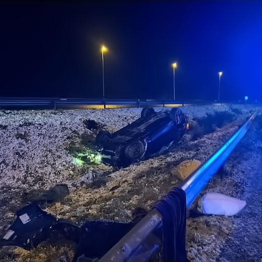 Upside-down car at night after a fatal accident.