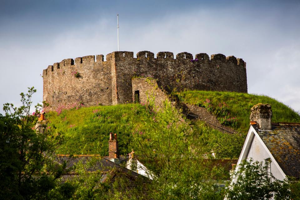 Norman castle overlooking town rooftops.