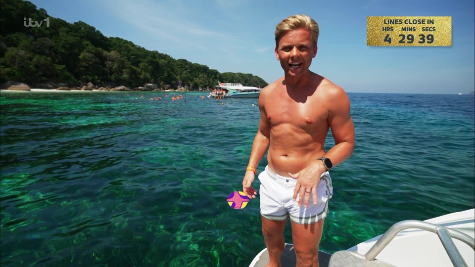 Jeff Brazier shirtless on a boat in tropical waters.