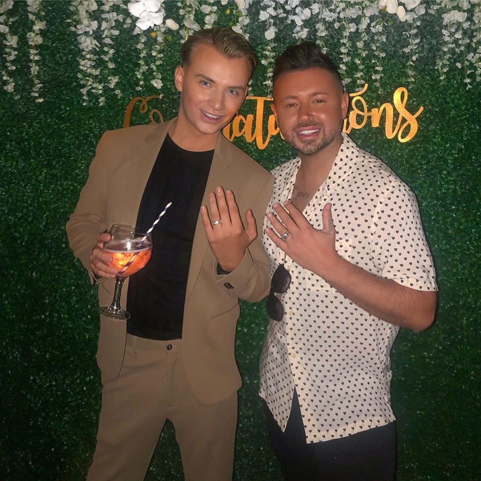 Harry Derbidge and Dean Rowland, engaged, showing off rings.