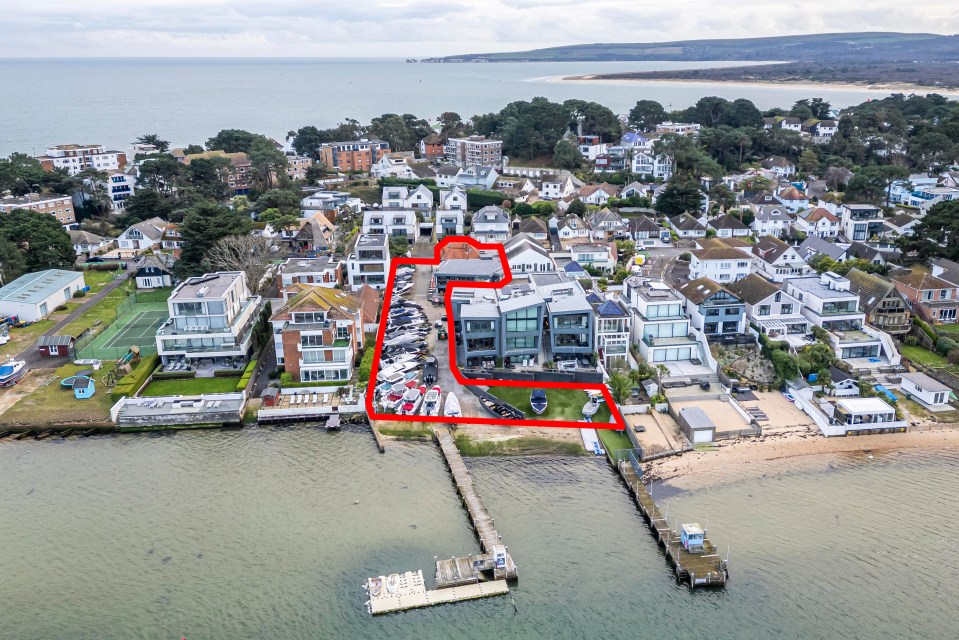 Aerial view of a proposed development site in Sandbanks, outlining new luxury flats and a restaurant near a boatyard.