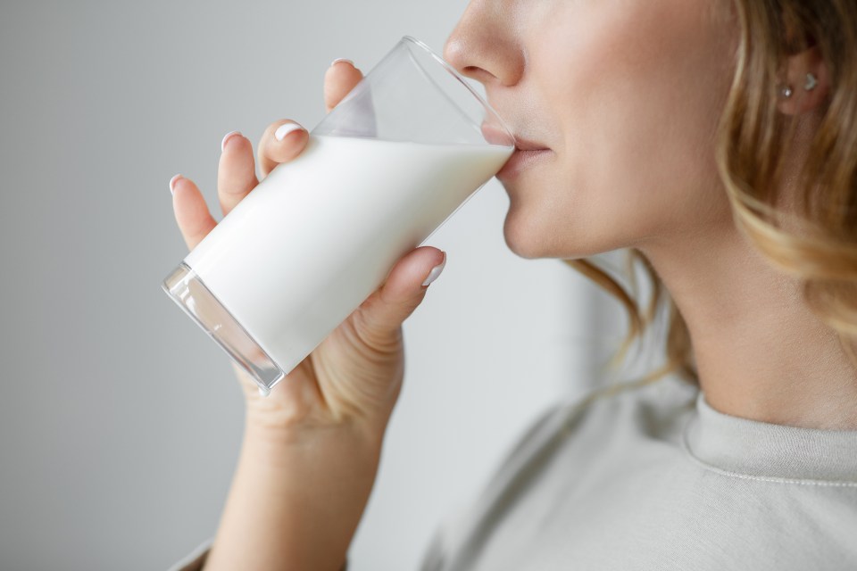 Woman drinking a glass of milk.