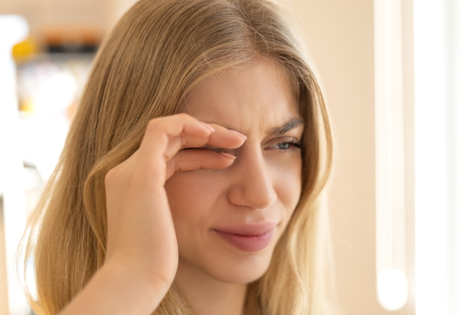 Woman rubbing her eye.