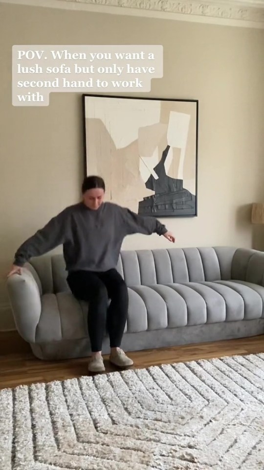 Woman sitting on a refurbished secondhand sofa.