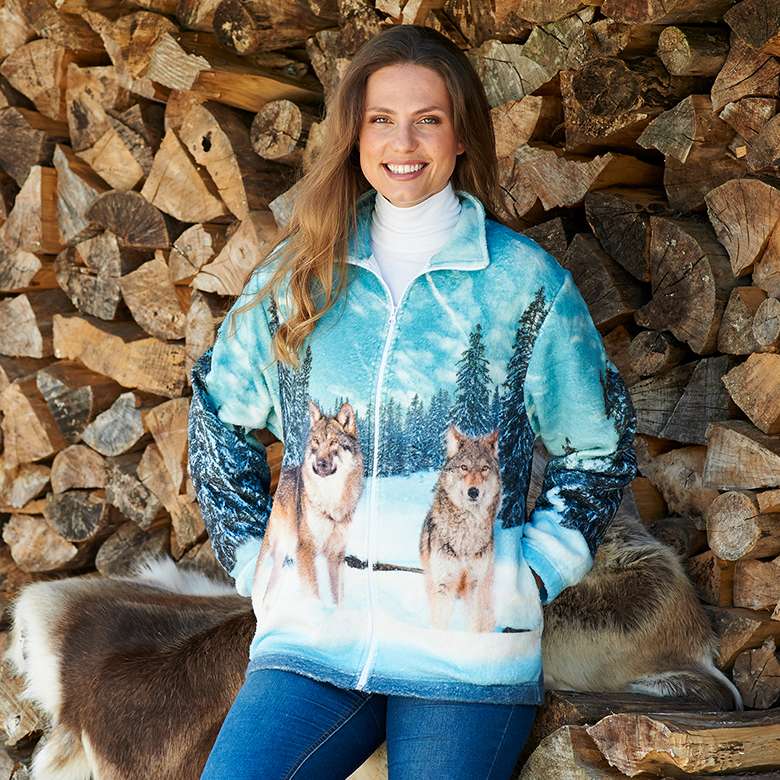 Woman wearing a wolf-print fleece jacket.