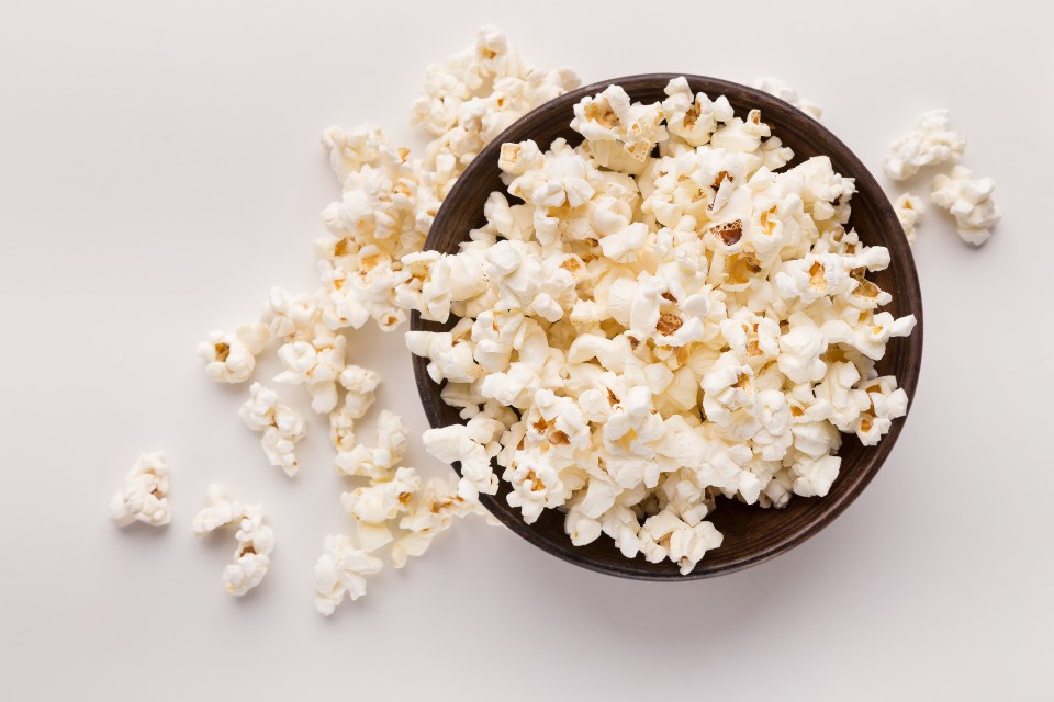 A bowl of popcorn on a white background.