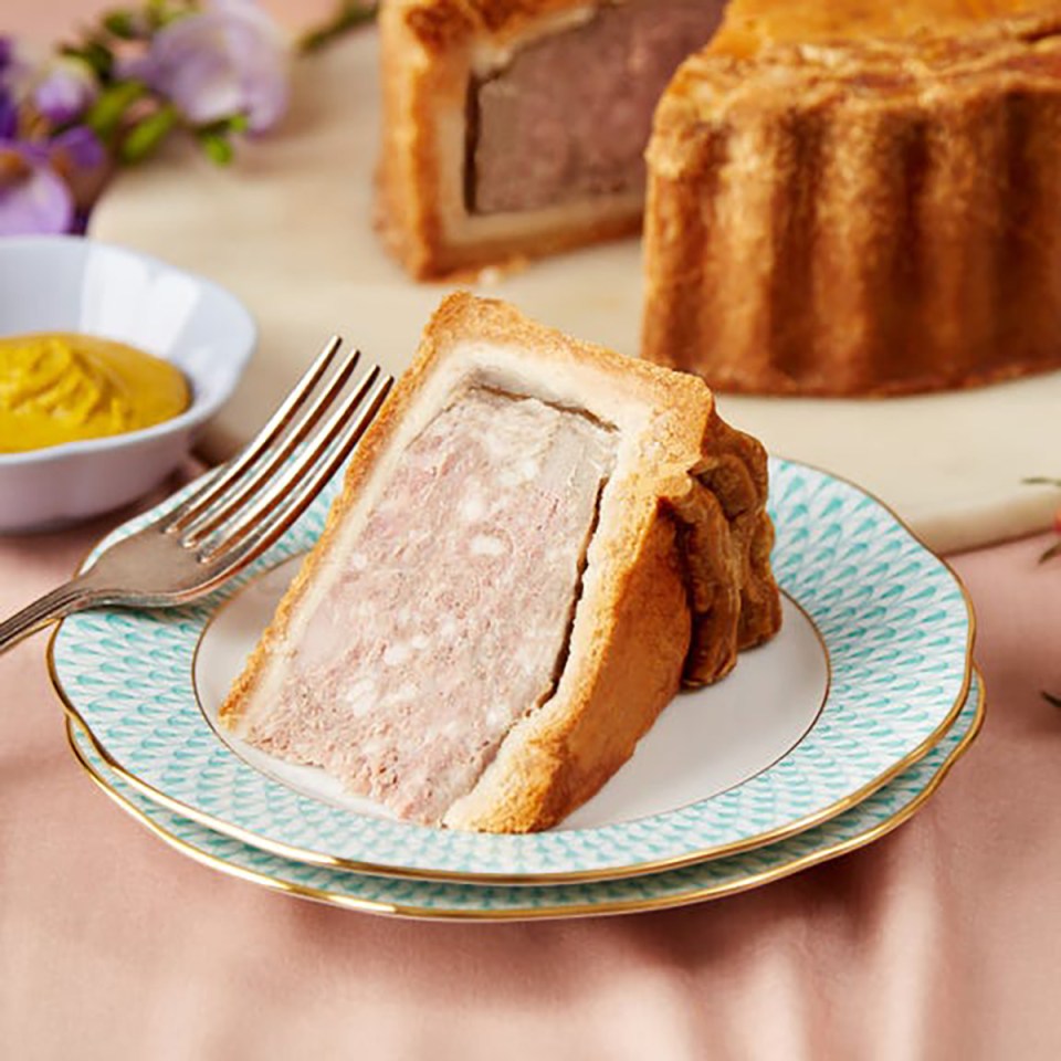 Slice of pork pie on a plate.