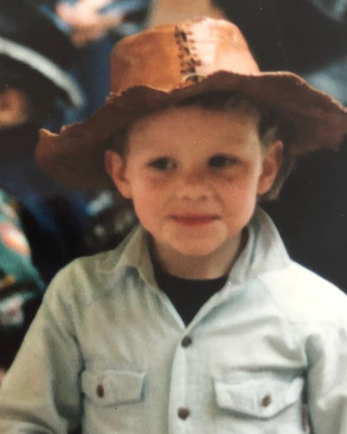 Young boy wearing a cowboy hat.