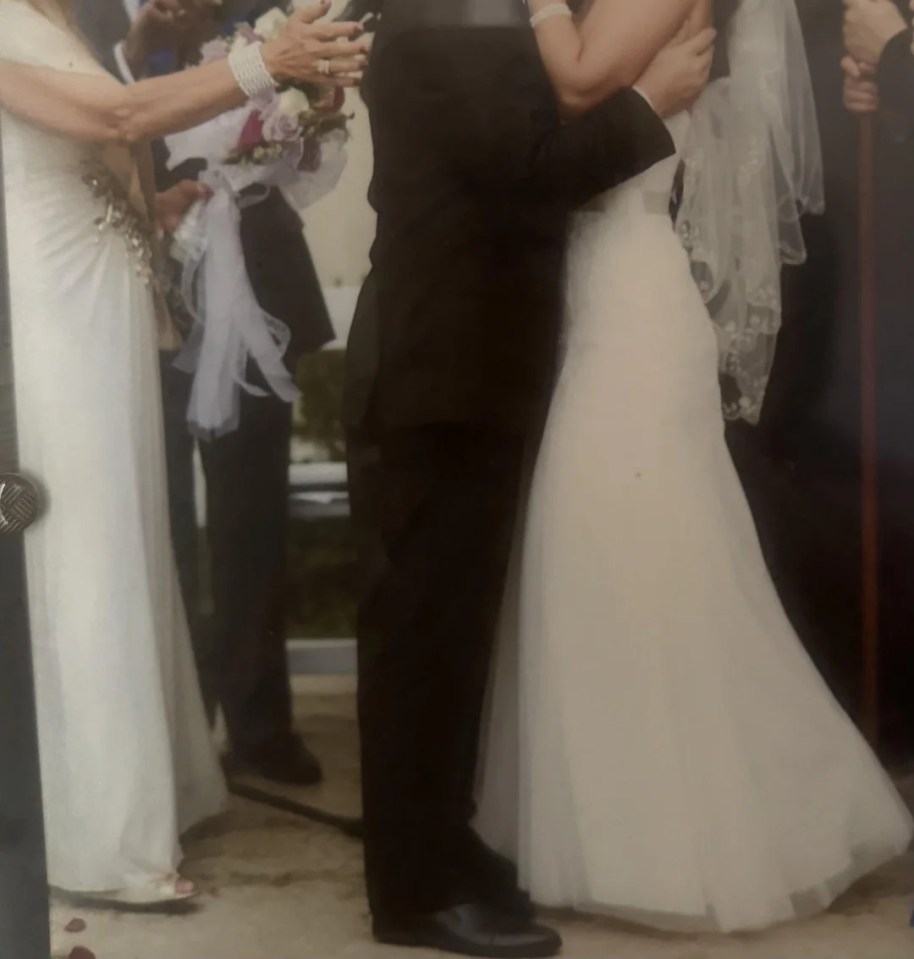 Bride and groom embracing at wedding ceremony.