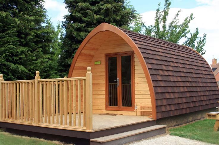 Wooden glamping pod with a deck.