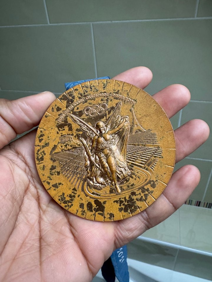 Paris 2024 Olympic medal in hand.